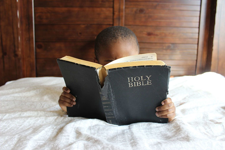 kid reading holy bible